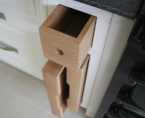 Pull out oak kitchen trays with finger pull drawer above